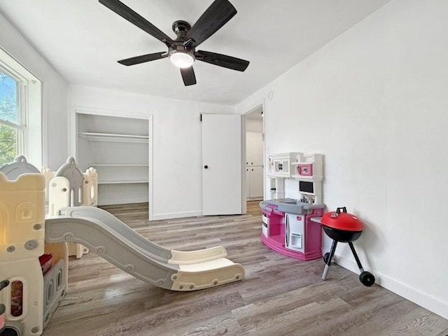 213 1st Ave E, Truman, MN 56088 - recreation room with wood finished floors, baseboards, and ceiling fan