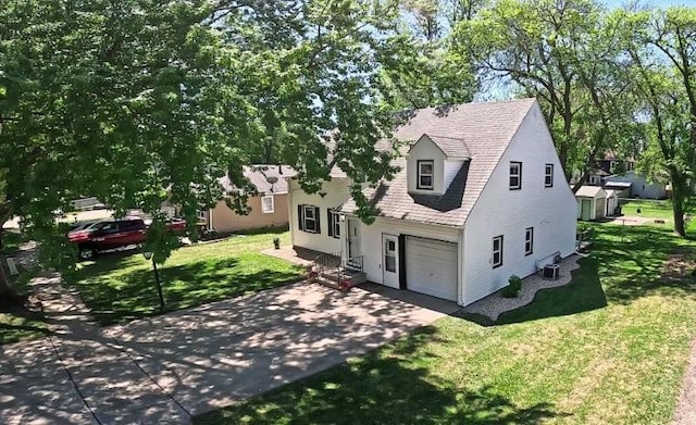 213 1st Ave E, Truman, MN 56088 - view of front facade with driveway, a front lawn, an attached garage, and a shingled roof