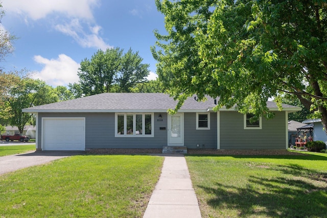 ranch-style home with a front yard, driveway, a garage, and a shingled roof