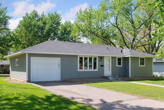 ranch-style home with a garage, asphalt driveway, a front lawn, and roof with shingles