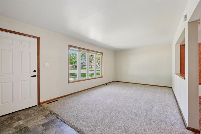 carpeted foyer with baseboards