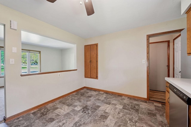 spare room featuring ceiling fan and baseboards