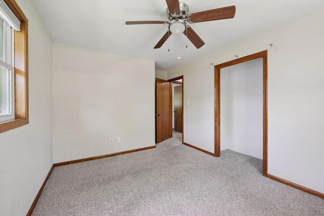 unfurnished bedroom with carpet flooring, baseboards, and ceiling fan