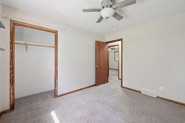 unfurnished bedroom with carpet flooring, a ceiling fan, a closet, and baseboards