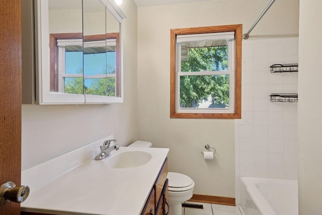 bathroom with plenty of natural light, toilet, vanity, and tile patterned floors