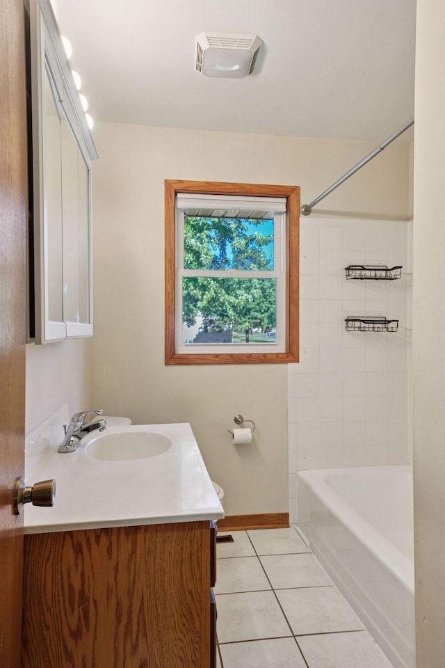 full bathroom with tile patterned flooring, vanity, baseboards, and  shower combination