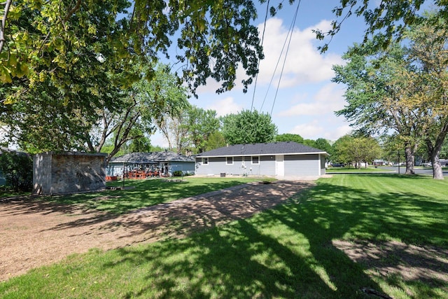 view of green lawn featuring a storage unit and an outdoor structure