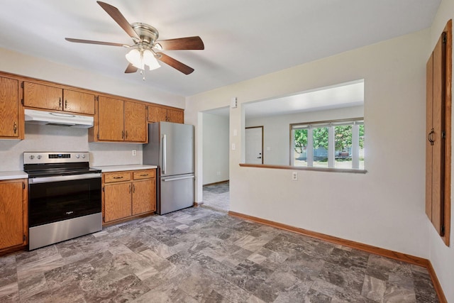 kitchen featuring stainless steel appliances, under cabinet range hood, ceiling fan, and brown cabinets