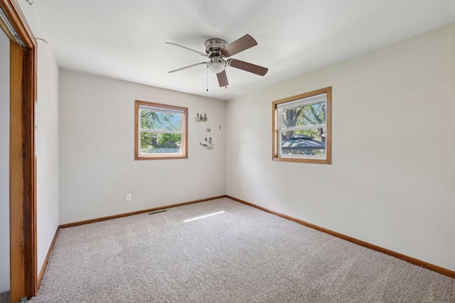 unfurnished room with carpet floors, ceiling fan, and baseboards