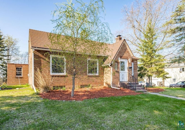 1815 Carlton Ave, Cloquet, MN 55720 - tudor home with a front lawn, a chimney, and brick siding