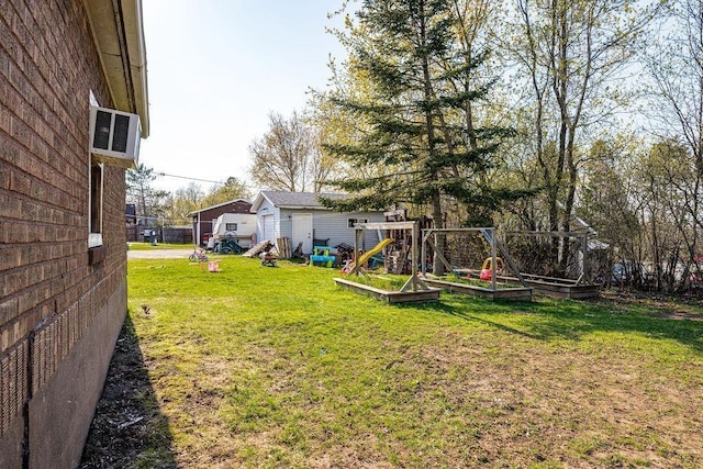 1815 Carlton Ave, Cloquet, MN 55720 - view of grassy yard featuring a garden, a playground, and an outbuilding