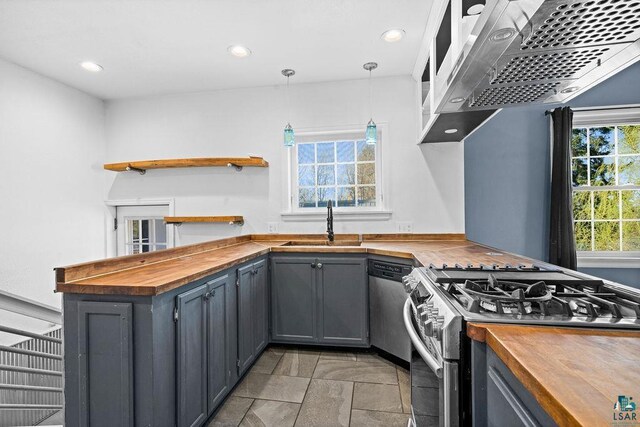 1815 Carlton Ave, Cloquet, MN 55720 - kitchen with wood counters, stainless steel appliances, a sink, recessed lighting, and range hood