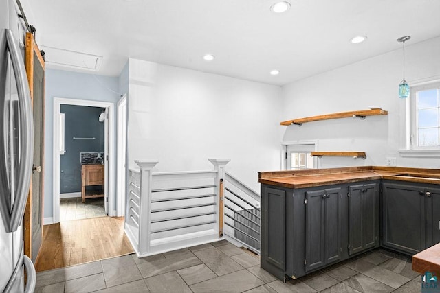 1815 Carlton Ave, Cloquet, MN 55720 - kitchen featuring butcher block counters, freestanding refrigerator, recessed lighting, open shelves, and decorative light fixtures