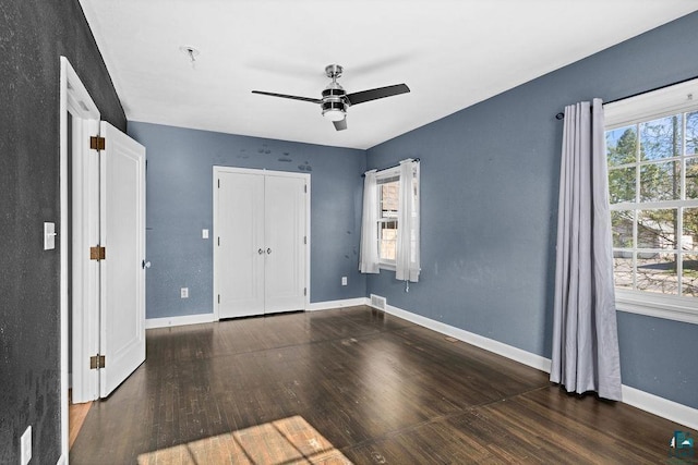 1815 Carlton Ave, Cloquet, MN 55720 - unfurnished bedroom with wood finished floors, baseboards, a ceiling fan, and a closet
