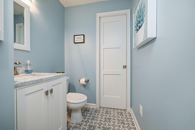 2917 85th St E, Inver Grove Heights, MN 55076 - half bath featuring toilet, vanity, baseboards, and tile patterned flooring
