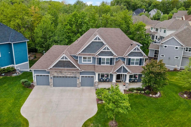 5315 Ranchview Ln N, Plymouth, MN 55446 - view of front of house featuring concrete driveway, a front yard, stone siding, a garage, and a porch