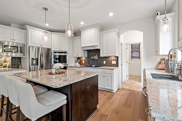 5315 Ranchview Ln N, Plymouth, MN 55446 - kitchen with stainless steel appliances, a sink, recessed lighting, white cabinetry, and decorative backsplash