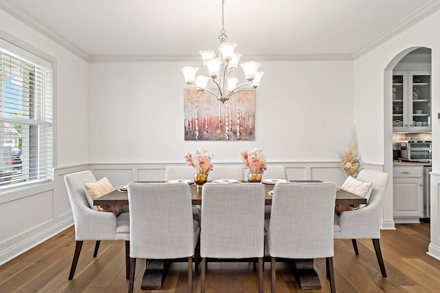 5315 Ranchview Ln N, Plymouth, MN 55446 - dining room featuring a chandelier, crown molding, dark wood-style floors, wainscoting, and a decorative wall