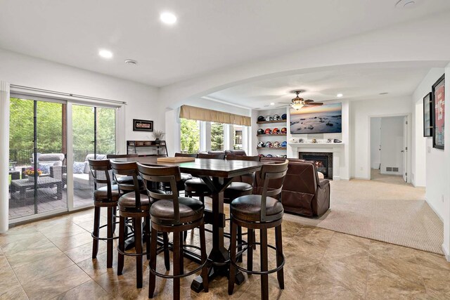 5315 Ranchview Ln N, Plymouth, MN 55446 - dining space with a ceiling fan, arched walkways, recessed lighting, a lit fireplace, and baseboards