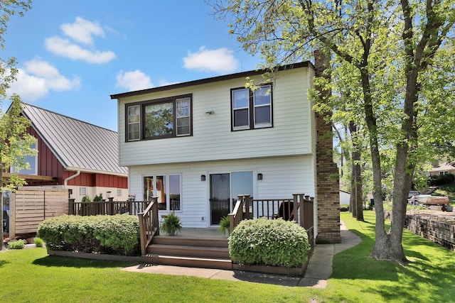 1379 7th Ave SE, Forest Lake, MN 55025 - rear view of house with a wooden deck and a lawn