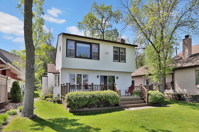 1379 7th Ave SE, Forest Lake, MN 55025 - back of property featuring a wooden deck, a lawn, and a chimney