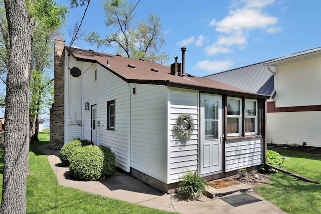 1379 7th Ave SE, Forest Lake, MN 55025 - rear view of property with a chimney and a lawn