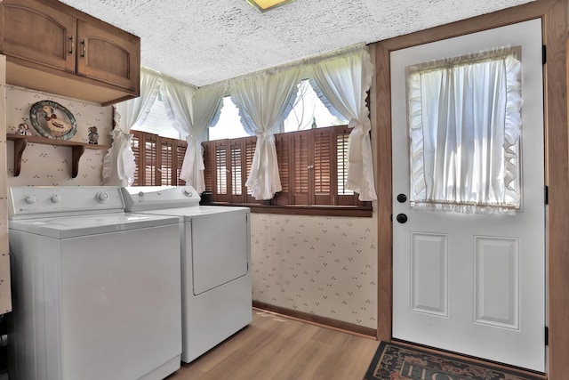 1379 7th Ave SE, Forest Lake, MN 55025 - washroom with independent washer and dryer, wallpapered walls, cabinet space, light wood-style flooring, and baseboards