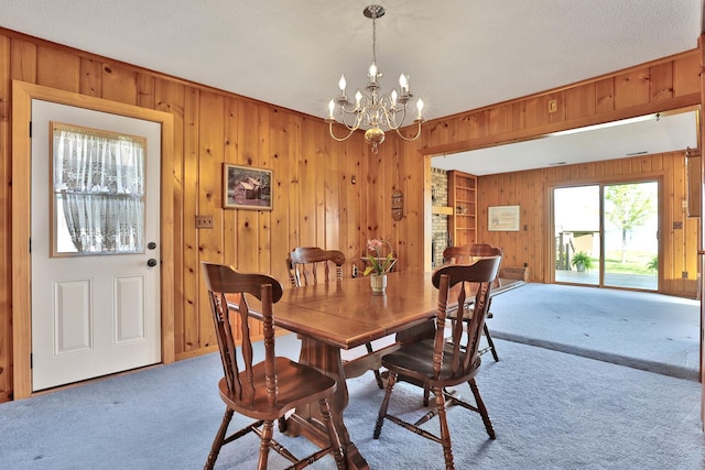 1379 7th Ave SE, Forest Lake, MN 55025 - dining room with carpet flooring, wood walls, and a chandelier