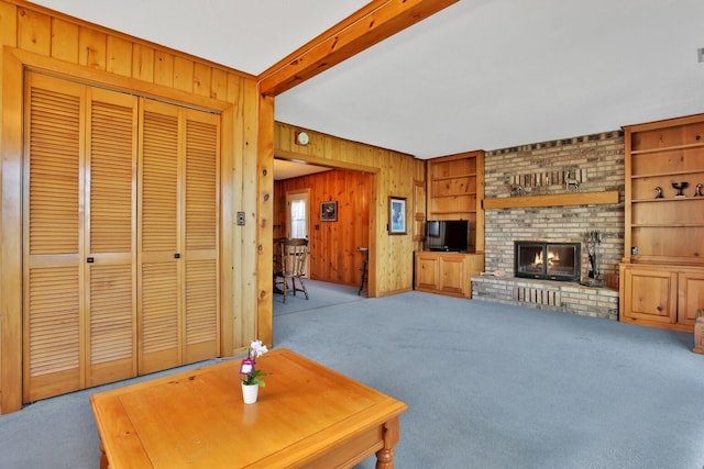 1379 7th Ave SE, Forest Lake, MN 55025 - carpeted living room featuring wooden walls and a fireplace