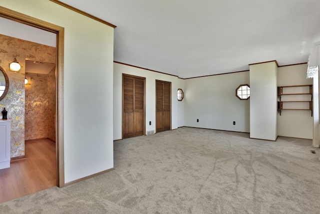 1379 7th Ave SE, Forest Lake, MN 55025 - unfurnished living room featuring carpet flooring, baseboards, and ornamental molding