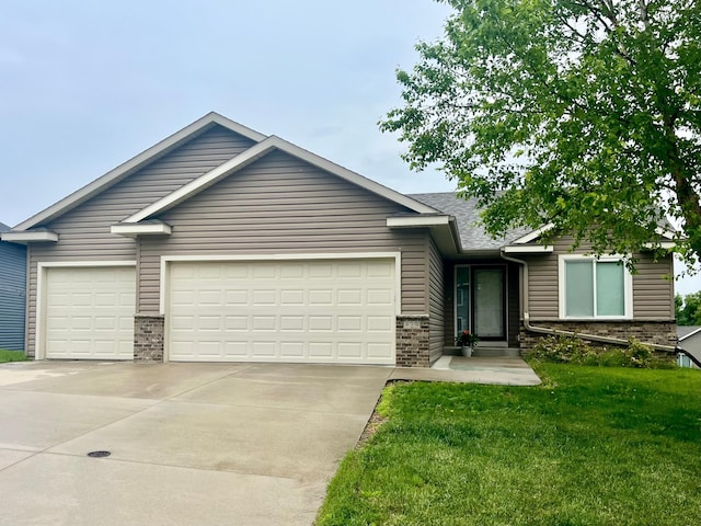 829 Dubuque Blvd, Zumbrota, MN 55992 - view of front facade with concrete driveway, an attached garage, a front yard, and brick siding