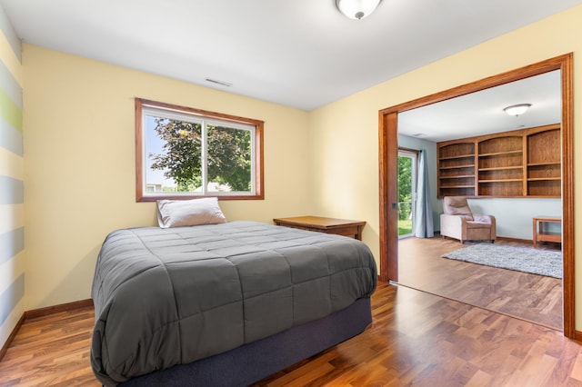 829 Dubuque Blvd, Zumbrota, MN 55992 - bedroom with access to exterior and wood finished floors