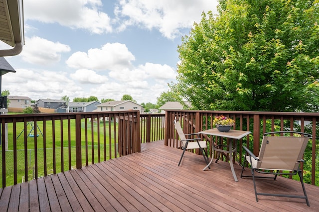 829 Dubuque Blvd, Zumbrota, MN 55992 - wooden terrace featuring outdoor dining area, a yard, and a residential view