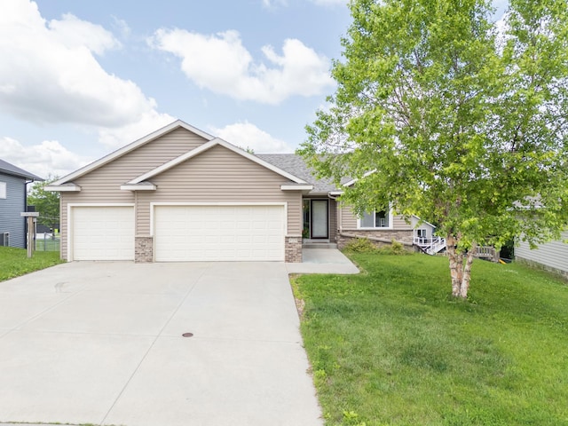 829 Dubuque Blvd, Zumbrota, MN 55992 - view of front of property with concrete driveway, a front lawn, and an attached garage