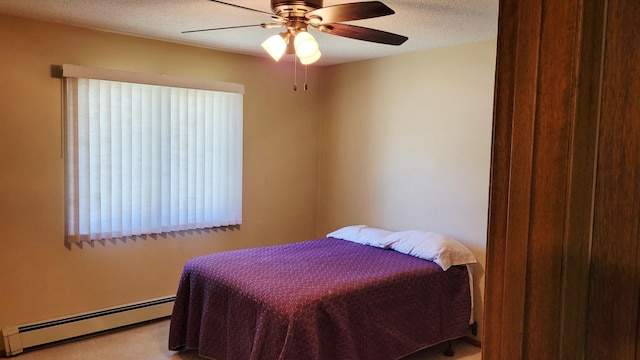 bedroom with baseboard heating, carpet floors, and ceiling fan