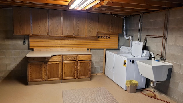 washroom featuring washing machine and clothes dryer and cabinet space