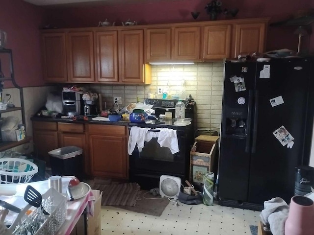 411 5th St, Montevideo, MN 56265 - kitchen with black fridge, brown cabinetry, and tasteful backsplash