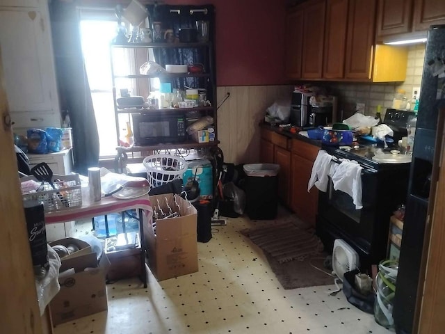 411 5th St, Montevideo, MN 56265 - kitchen with black appliances, healthy amount of natural light, and wainscoting