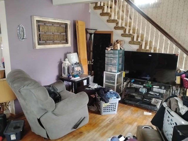 411 5th St, Montevideo, MN 56265 - living area featuring wood finished floors, stairway, and wallpapered walls