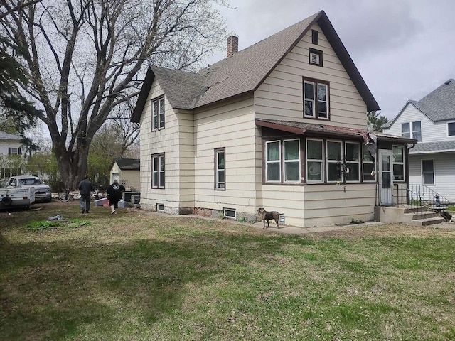 411 5th St, Montevideo, MN 56265 - view of side of home featuring a chimney, a shingled roof, and a lawn