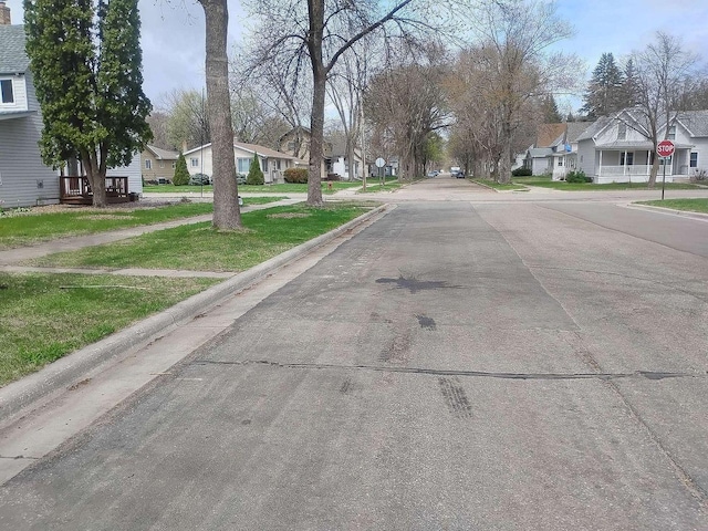 411 5th St, Montevideo, MN 56265 - view of asphalt street featuring traffic signs, a residential view, curbs, and sidewalks