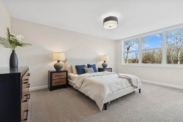 bedroom featuring baseboards and light colored carpet