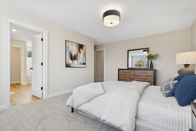 bedroom featuring carpet flooring, baseboards, and connected bathroom