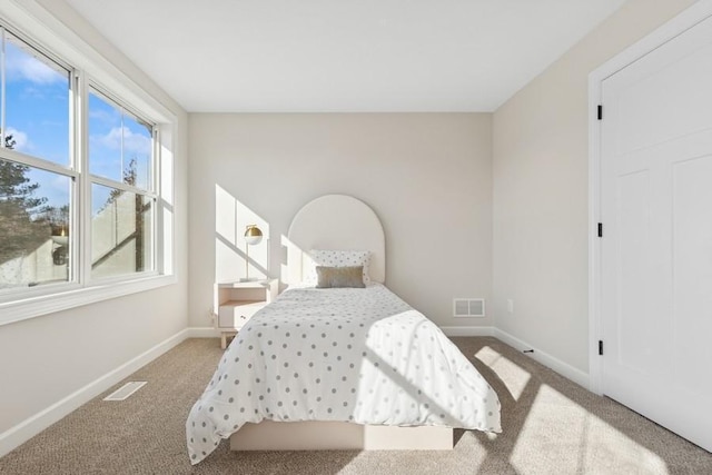 bedroom featuring carpet floors and baseboards