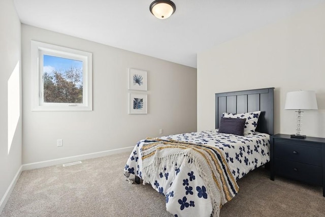 carpeted bedroom featuring baseboards