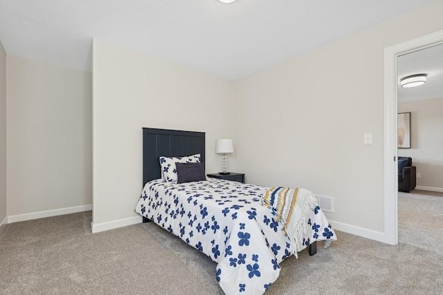 bedroom featuring carpet and baseboards