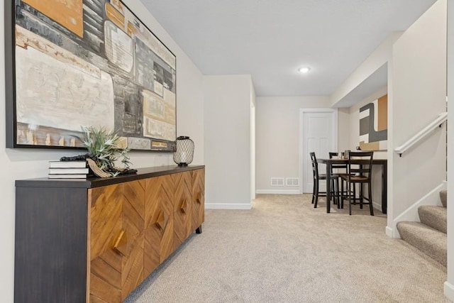 hallway featuring carpet, baseboards, stairs, and recessed lighting
