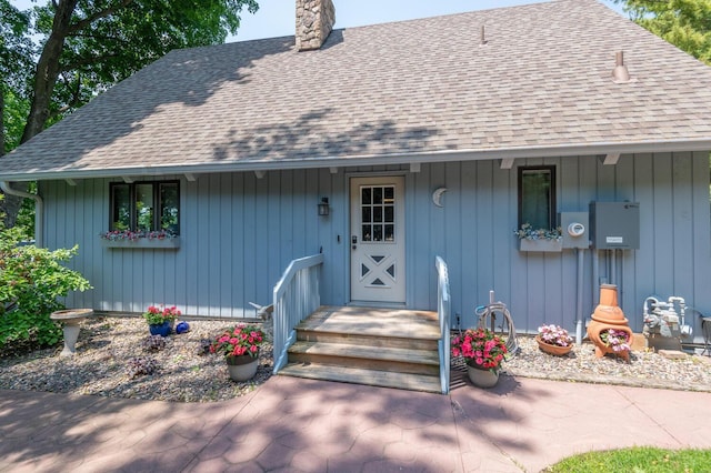 1749 Avocet Ln, Mound, MN 55364 - view of front facade with a chimney and a shingled roof