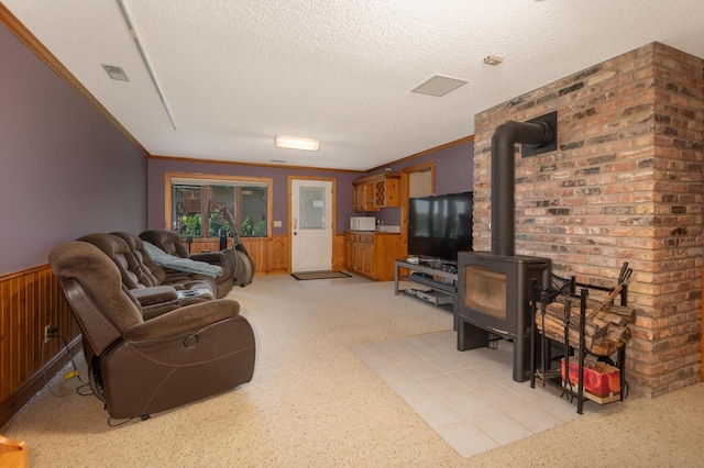 1749 Avocet Ln, Mound, MN 55364 - living room with a wood stove, wainscoting, a textured ceiling, wooden walls, and light carpet