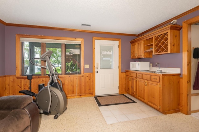 1749 Avocet Ln, Mound, MN 55364 - kitchen with white microwave, wainscoting, open shelves, light countertops, and wood walls